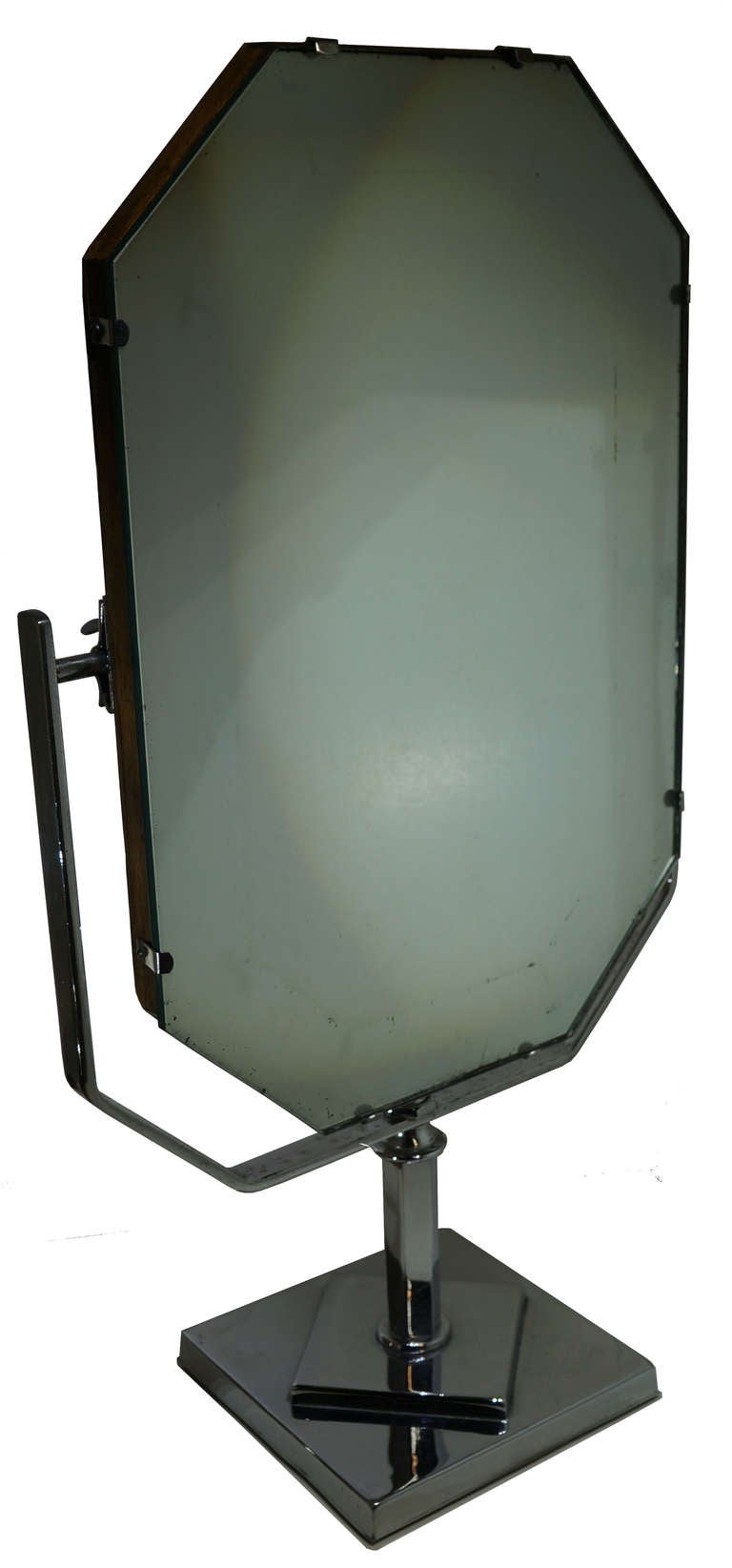 Octagonal mirror with patina finish. Appears to have original wood backing and chrome base. The chrome arms of the mirror have begun to blister, adding to the character of the mirror.

*Not available for sale or to ship in the state of California.