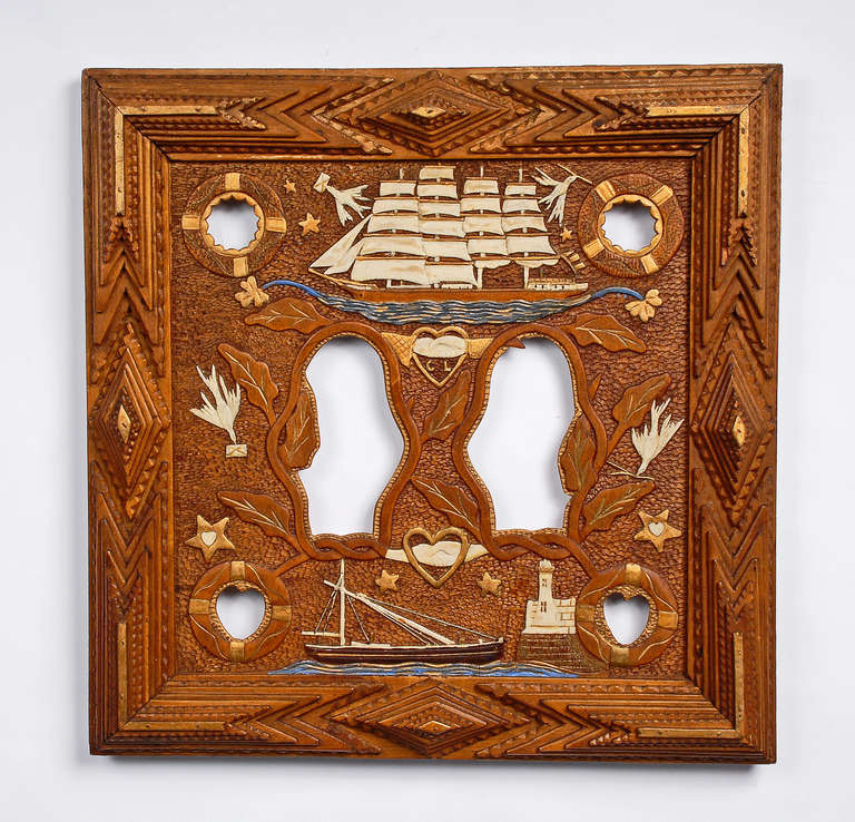 Fine nautical inspired tramp art frame with relief carvings of ships, hearts, birds, lighthouse, stars and life preservers. Illustrated in 'A Legacy in Tramp Art' on page 143.