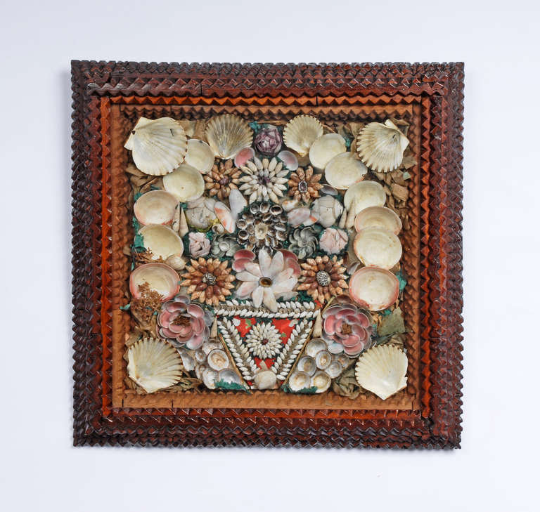 Victorian era tramp art shadow box frame with a collage of sea shells in the shape of flowers. In the style of sailor's valentines popular gifts sailors would give to their sweethearts after returning from a voyage at sea. Circa 1870s - 1880s.