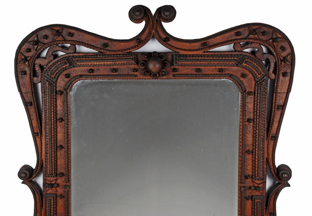 Unusually designed and executed tramp art mirror frame with swirl sides, stars and spheres. Impressive size and presence. Illustrated in the book Tramp Art Another Notch, Folk Art from the Heart on page 229.