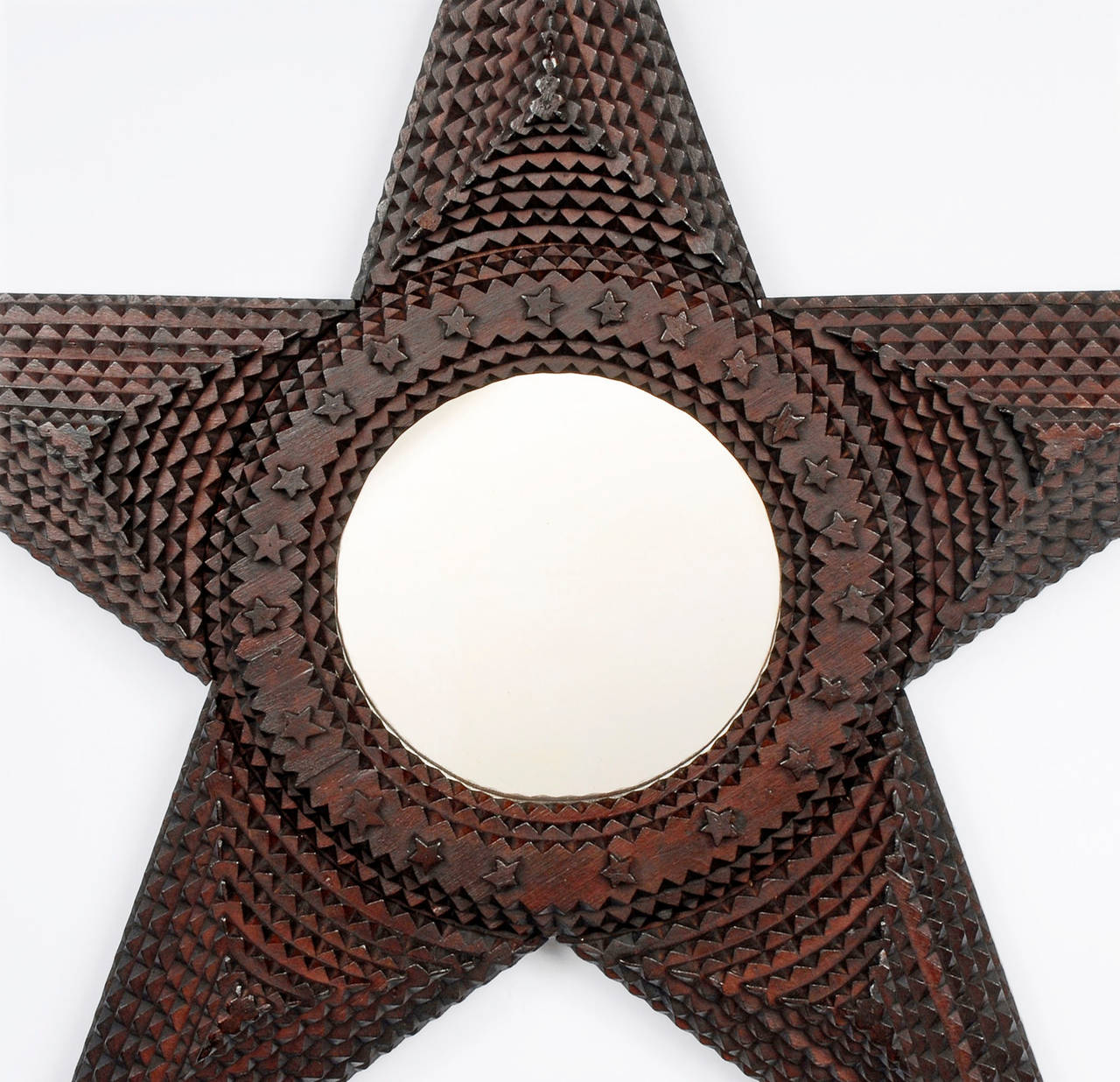 Fine large star-shaped Tramp Art mirror embellished with carved stars and a round opening. Deeply layered and made out of whiskey crates. Rare form.

Found in upstate NY.
circa 1890.
