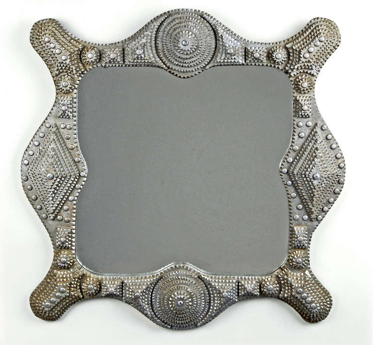 Painted tramp art wave-sided mirror embellished with metal tacks, large roundels and diamond shapes. Illustrated in Tramp Art Another Notch, Folk Art from the Heart on page 241.