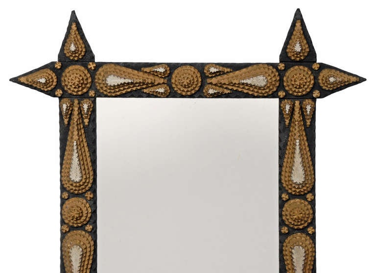 Fine three color painted tramp art mirror decorated with layered rosettes and teardrop shapes.