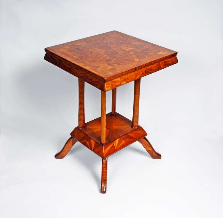 A fine handsome folk marquetry stand with a bottom shelf. It is embellished with an abundance of different shaped inlaid woods resembling a crazy quilt. Its top has a large star with a smaller central star and the edges are obsessively covered with