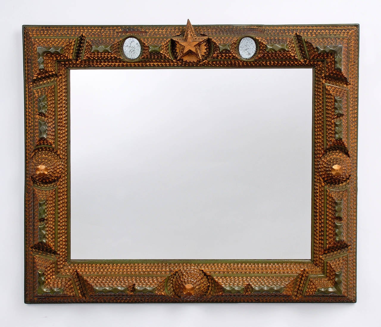 Fine tramp art mirror frame with painted decoration, a large central star and inset mirrors. The frame exhibits a wonderful original painted surface and is deeply layered.