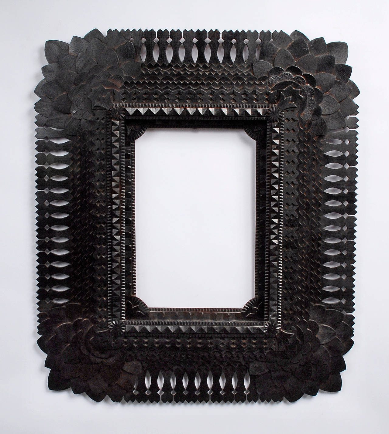 Superb sunflower cornered tramp art frame made by the important historical artist tramp artist John Zubersky (1884 – 1950). Large & robust with fine detailed work this frame exhibits all of Zubersky’s  signature elements. Big impressive sunflower