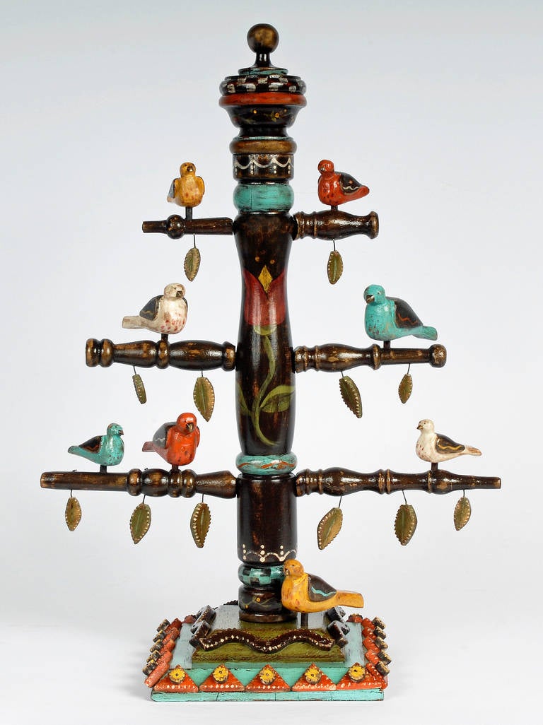 A fine whimsical bird tree by contemporary tramp artist Angie Dow. Angie uses colorful and expressive carvings to enhance her work showing a deep-rooted respect for the historical techniques employed by the talented tramp artists that preceded her.