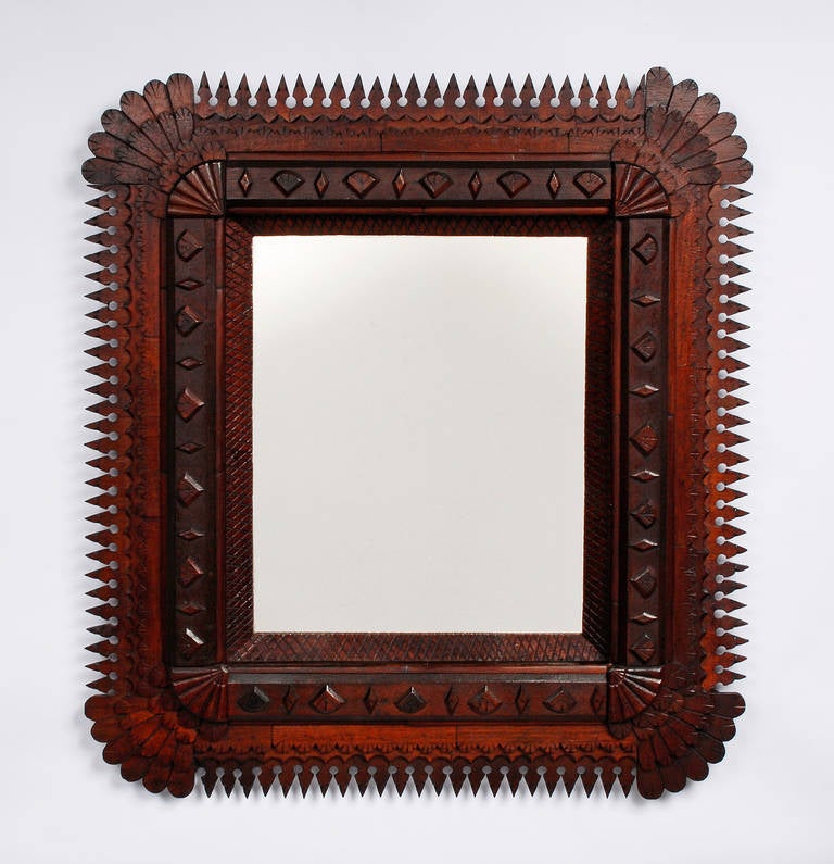 An impressive large tramp art mirror with carved fan embellishments and points surround. Circa 1890s - 1900.