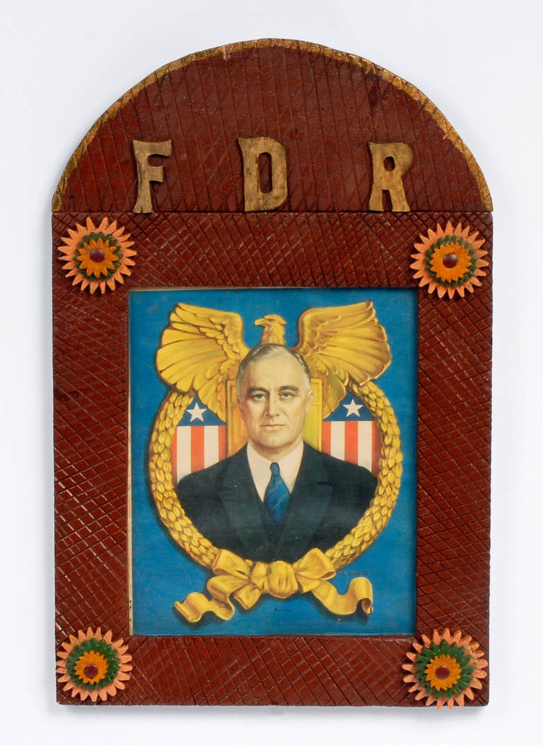 A patriotically inspired 'FDR' painted tramp art frame with a print of the young United States President, Franklin Delano Roosevelt. The frame is embellished with brightly painted rosettes. The print has a copyright date of 1934 and the frame is