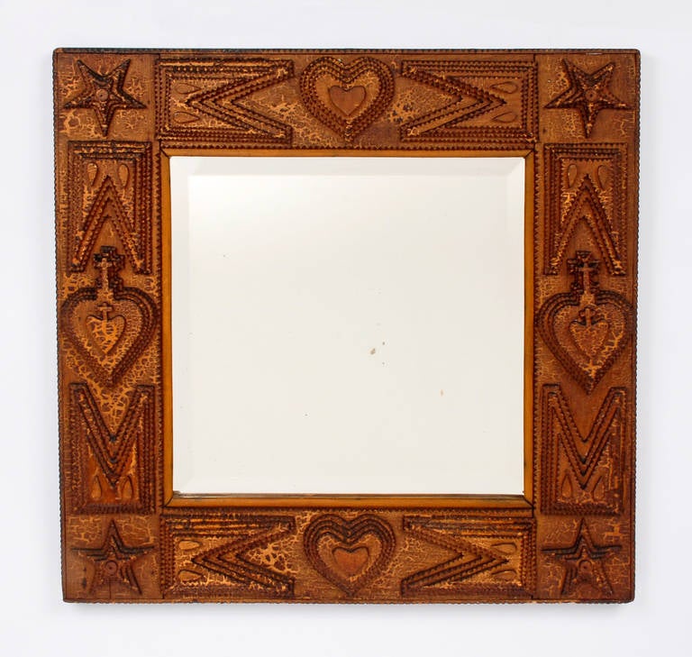 An expressive Tramp Art mirror decorated with hearts and stars. Great surface and has its original beveled mirror, circa 1880s.