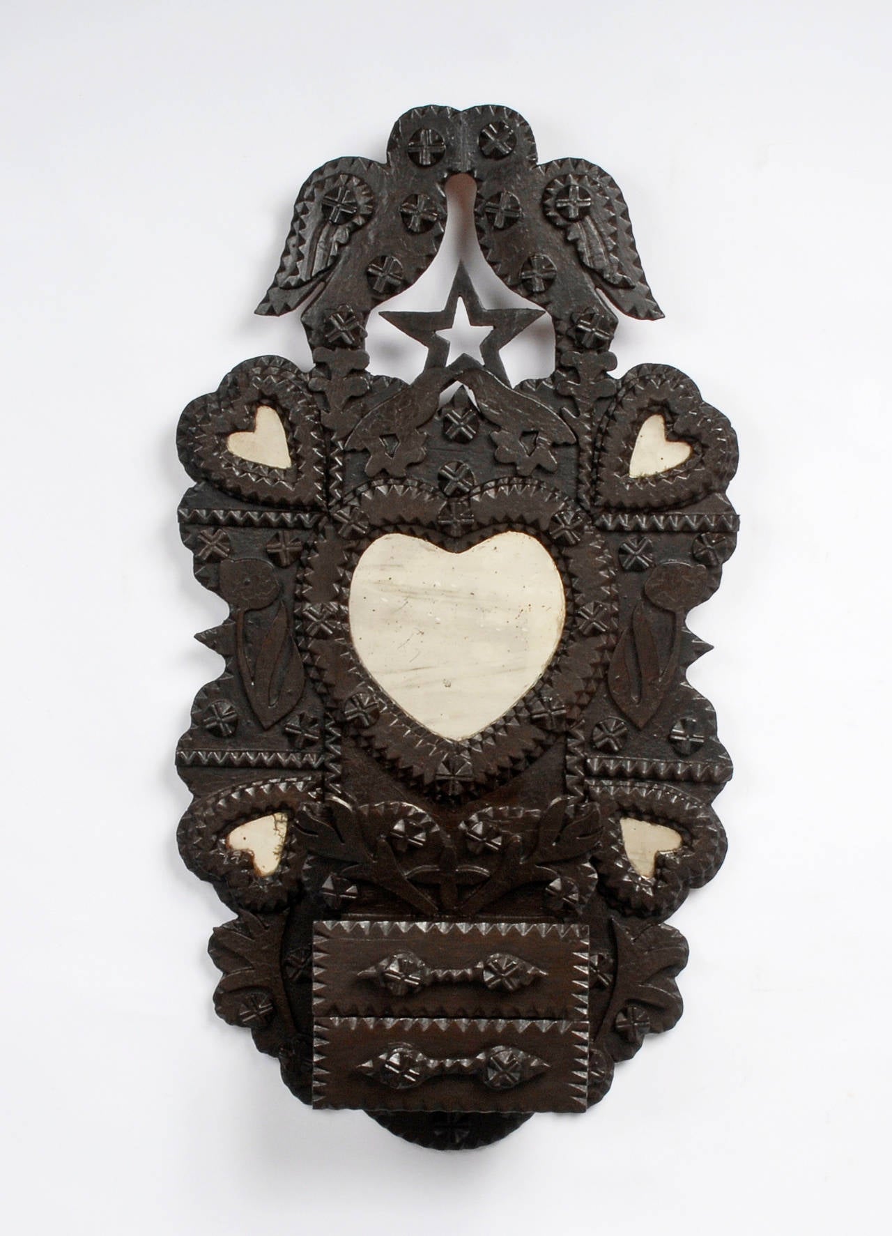 A superb Tramp Art ‘Kissing Doves’ wall sculpture by John Zadzora. This example is one of his most elaborate featuring his signature style incorporating five heart shaped mirrors, two drawers and a small compartment. Additionally he used some rather
