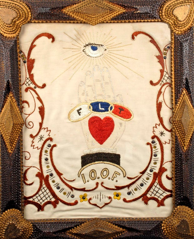 Fine tramp art frame with heart corners & a mounted 'Odd Fellow' embroidered textile. The tramp art frame is highlighted with gilding on the diamond designs and on the heart corners. The decorative elements on the frame are pleasing & deeply