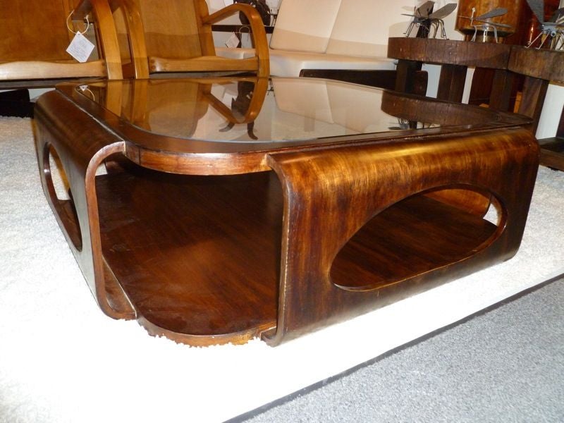 An amazing coffee table by Brazilian designer Jorge Zalszupin.  This coffee table has an inset glass top and four sides with bean shaped cut outs.  This table is one of Mr. Zalszupin's most famous designs.<br />
<br />
Mr. Zalszupin was born in