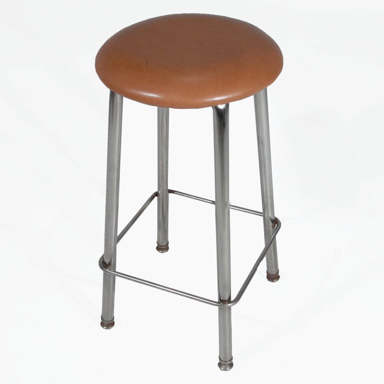 A set of three chrome and tan leather button stools on four solid legs with feet. Price is per stool and stools are available in dark brown and tan as well (13 total).

 