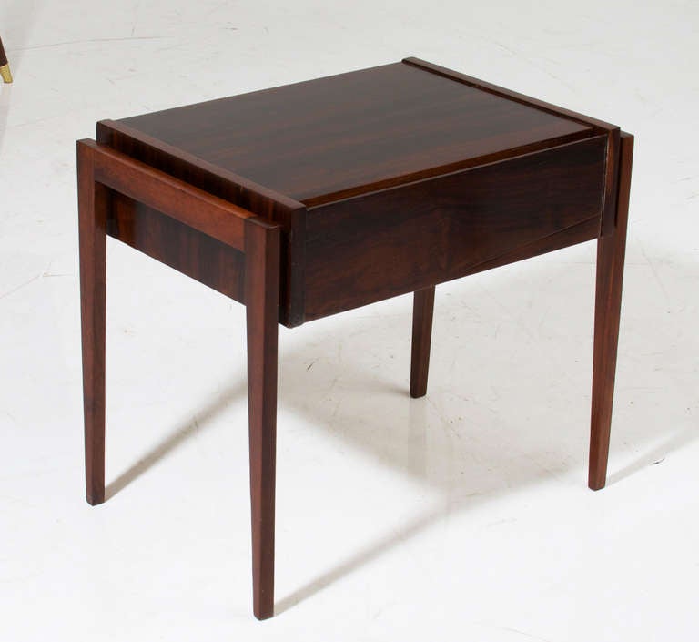 A small side table in exotic dark wood grains by Cimo from Brazil with a single drawer and slender tapered legs. 

     