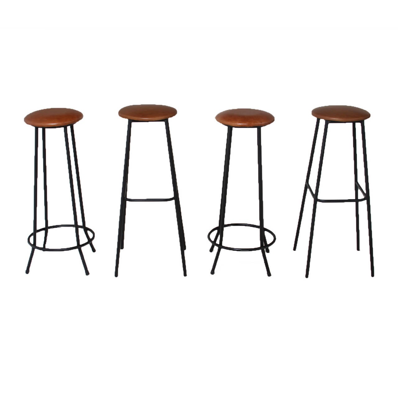 A simple designed set of iron stools with leather tops. The base of two of the stools have splayed out legs and the other two legs are straight down.

 