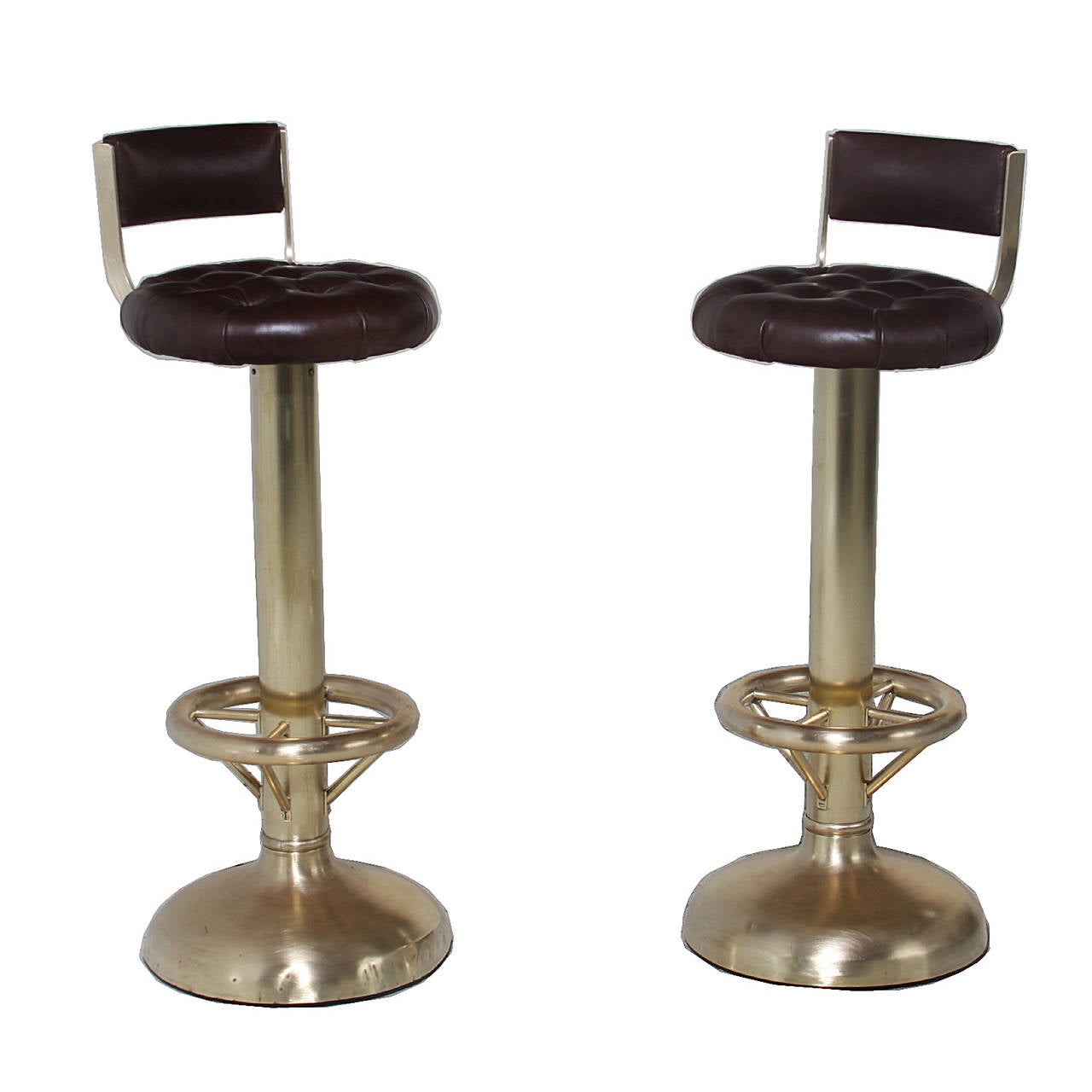 An elegant pair of stools from Brazil with burgundy leather tufted seating. The base is made of brass and is rounded at the end with a circular foot rest. 

Many pieces are stored in our warehouse, so please click on CONTACT DEALER under our logo
