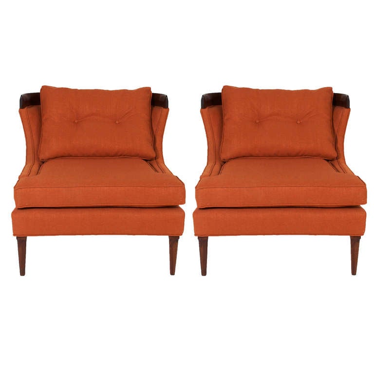 A pair of Erwin Lambeth chairs with Mahogany legs and back, upholstered in a burnt orange linen with piping and loose tufted back pillow. 

Seat depth: 18.5

Many pieces are stored in our warehouse, so please click on CONTACT DEALER under our