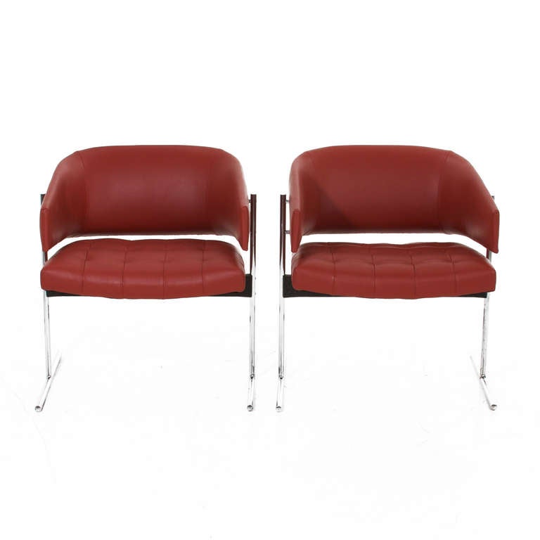 Beautiful pair of restored chromed steel & leather chairs by Jorge Zalszupin for L'Atelier, upholstered in tufted red leather. As seen in the photos, the chrome has patina consistent with age. These chairs are all made very substantively and are