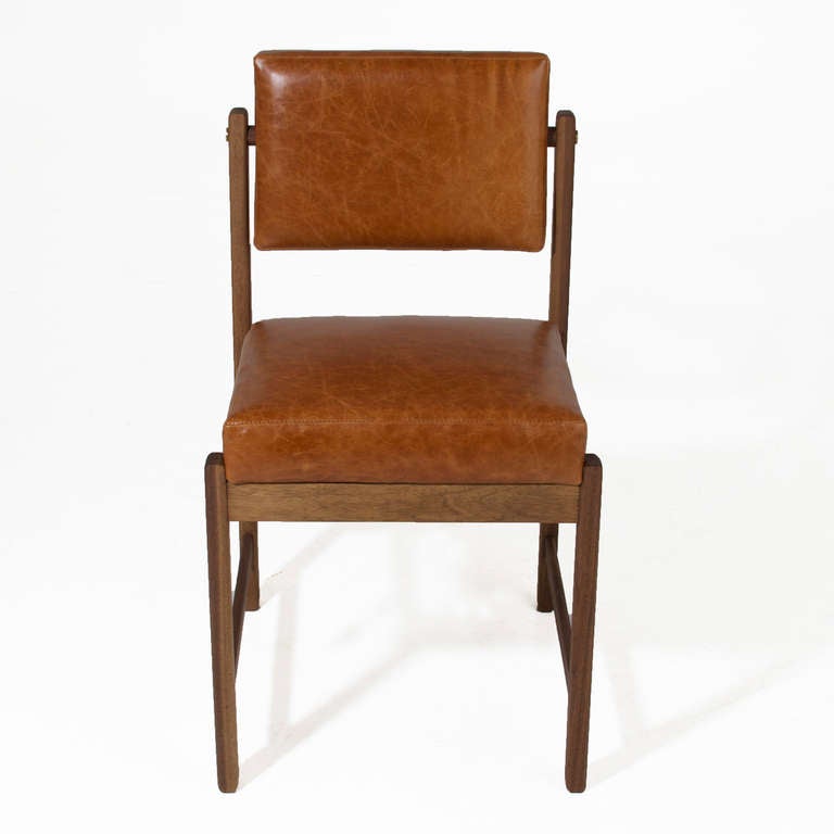 A custom, elegant solid wood dining chair available in a variety of woods and finishes with solid wood frame, pivoting back, and upholstered seat by Thomas Hayes Studio. The angle of the back creates good lumbar support. The frames are accented with