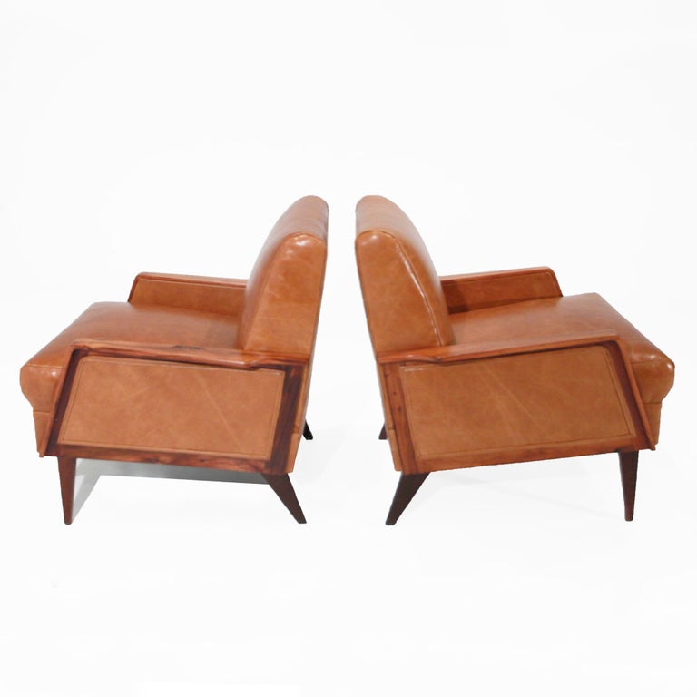 Pair of Rosewood and distressed caramel leather armchairs by Giuseppi