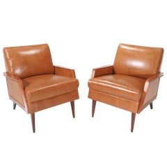 Pair of Rosewood and distressed caramel leather armchairs by Giuseppi Scapinelli