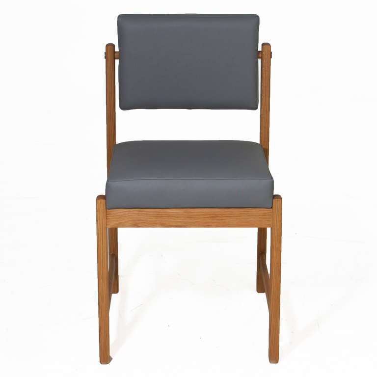 A custom, elegant solid wood dining chair available in a variety of woods and finishes with solid wood frame, pivoting back, and upholstered seat by Thomas Hayes Studio. The angle of the back creates good lumbar support. The frames are accented with