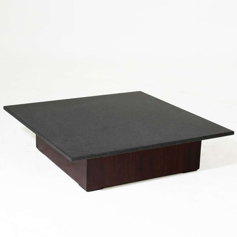 A low square coffee table with Brazilian exotic hardwood base and black granite top.

    