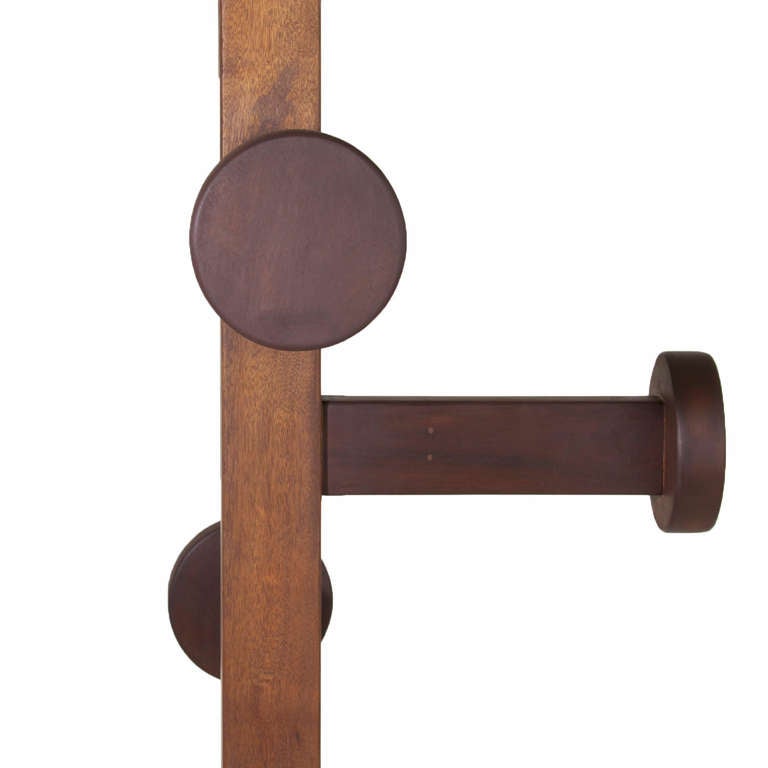 Solid Itauba wood hat stand/coat rack with four arms and round knobs at the end and two arms at the bottom with no knobs. 

Many pieces are stored in our warehouse, so please click on CONTACT DEALER under our logo below to find out if the pieces