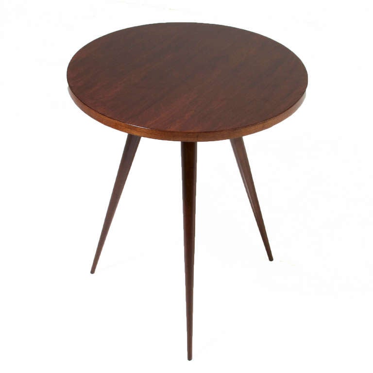 A solid round Brazilian Pau Ferro wood side table in the manner of Giuseppi Scapinelli balanced on three tapered sculptural solid wood legs.  

Many pieces are stored in our warehouse, so please click on CONTACT DEALER under our logo below to find