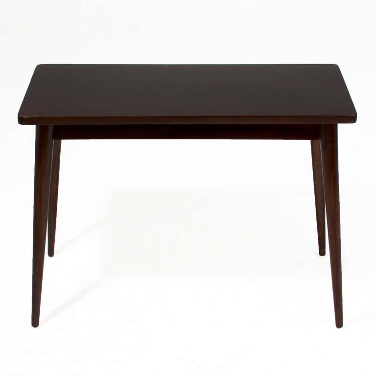 A side table or nightstand in solid exotic hardwood from Brazil with satin lacquer finish and splayed legs. 

 