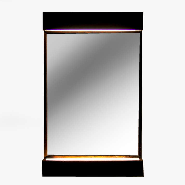 A vertical hanging mirror from Brazil with a shelf along the bottom with a built-in light covered in a glass diffuser. Top also has a down light which illuminates the mirror. Rare and stunning piece.

 
