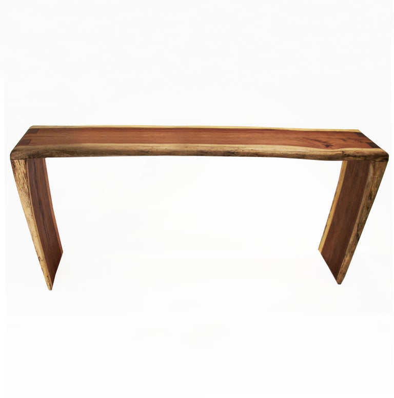 A one-of-a-kind sculptural solid Jatoba console table by Tunico T. Table has tapered, angled sides. Tunico T. lives in Brasilia with his wife and two of his children. He finds his raw materials in the surrounding â Cerrado, â the largest savannah