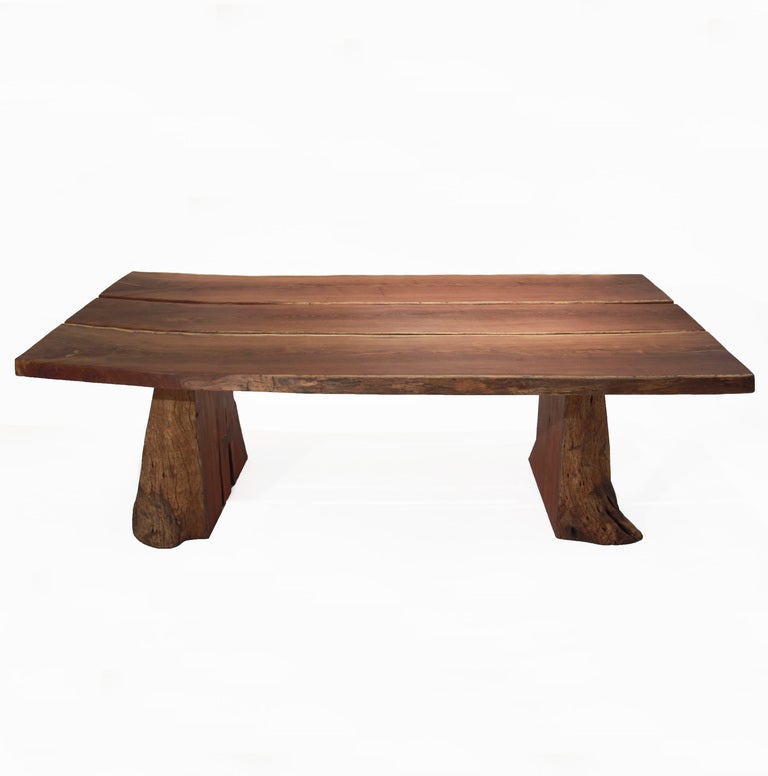 Massive, one-of-a-kind, solid Sucu Pira dining table by Tunico T. Te feet are made of Jatoba. The table is comprised of three massive slabs as the table top and a split log as the base.
Tunico T. lives in Brasilia with his wife and two of his