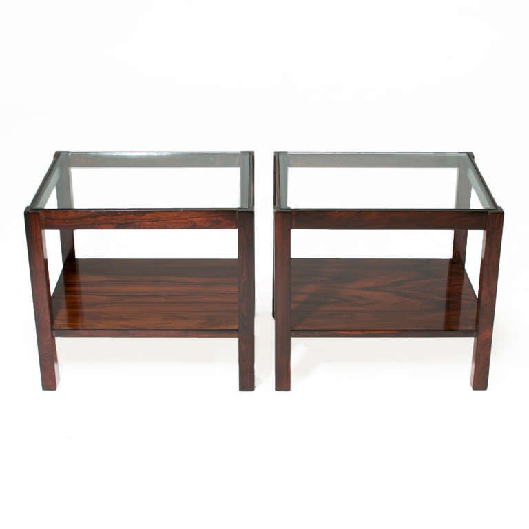 A pair of vintage solid Brazilian Jacaranda side tables with inset glass tops. 

 