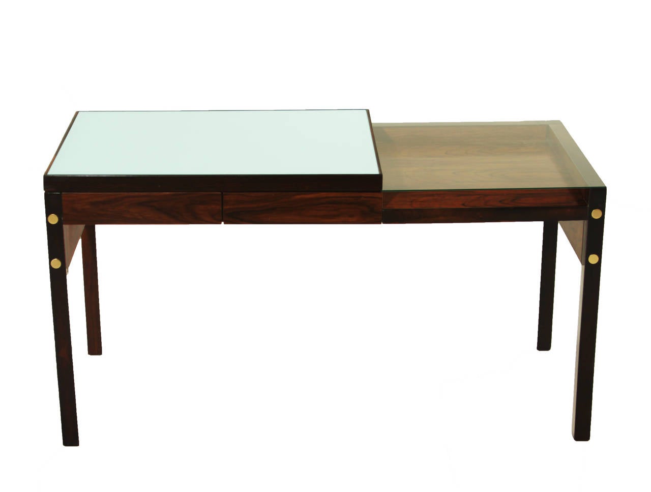 A stunning and rare two-tiered, glass top exotic hardwood desk by Brazil's Sergio Rodrigues. Top tier of the desk features reverse painted white glass and the lower tier is clear glass over a shallow cubby or display. The desk features two drawers