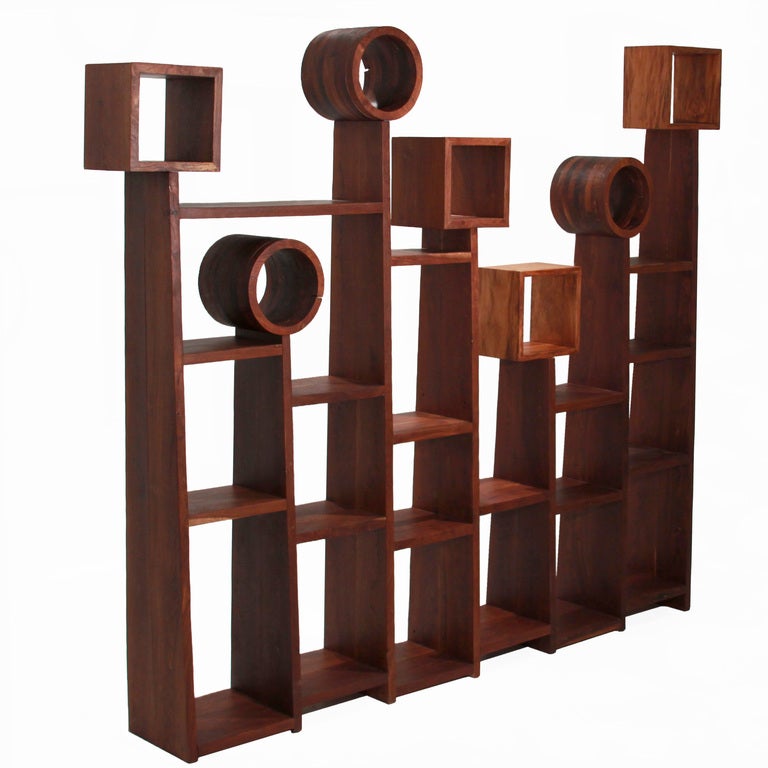 Large geometric bookshelf by Tunico T. One piece, of connected parts, made of exotic Brazilian hardwood, Sucu Pira Preta. It includes 20 shelves topped by circle and square finials. Tunico T. lives in Brasilia with his wife and two of his children.