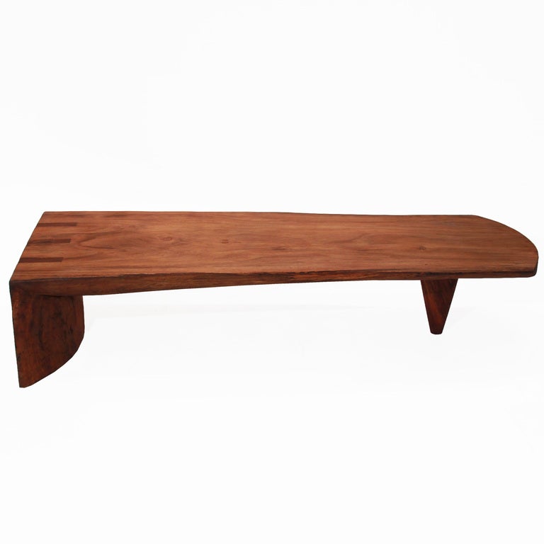 One-of-a-kind Tamboril coffee table or bench by Tunico T. One side is held by a semi-hemisphere of solid Tamboril, the other is a delicate yet sturdy cone. 

Tunico T. lives in Brasilia with his wife and two of his children. He finds his raw