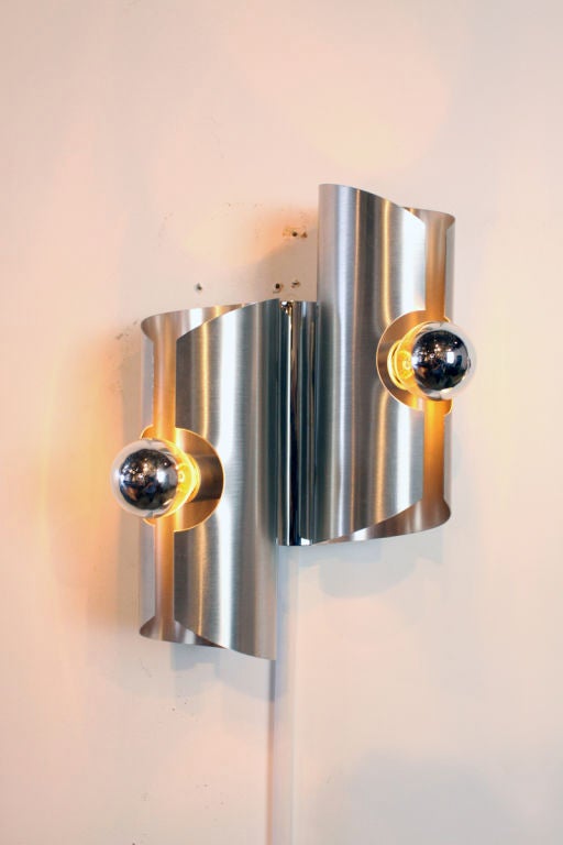 Chromed steel cylindrical sconces with chrome tipped bulbs attributed to Sciolari. A single pendant with 4 cylinders also available. A third sconce is also available.

Many pieces are stored in our warehouse, so please CONTACT US to find out if