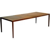 Walnut parsons table with two leaves by John Kapel for Glenn
