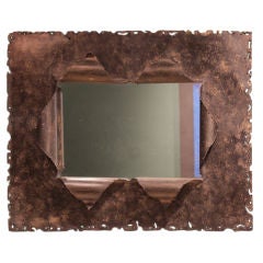 Vintage bronze framed mirror with torch cut edges