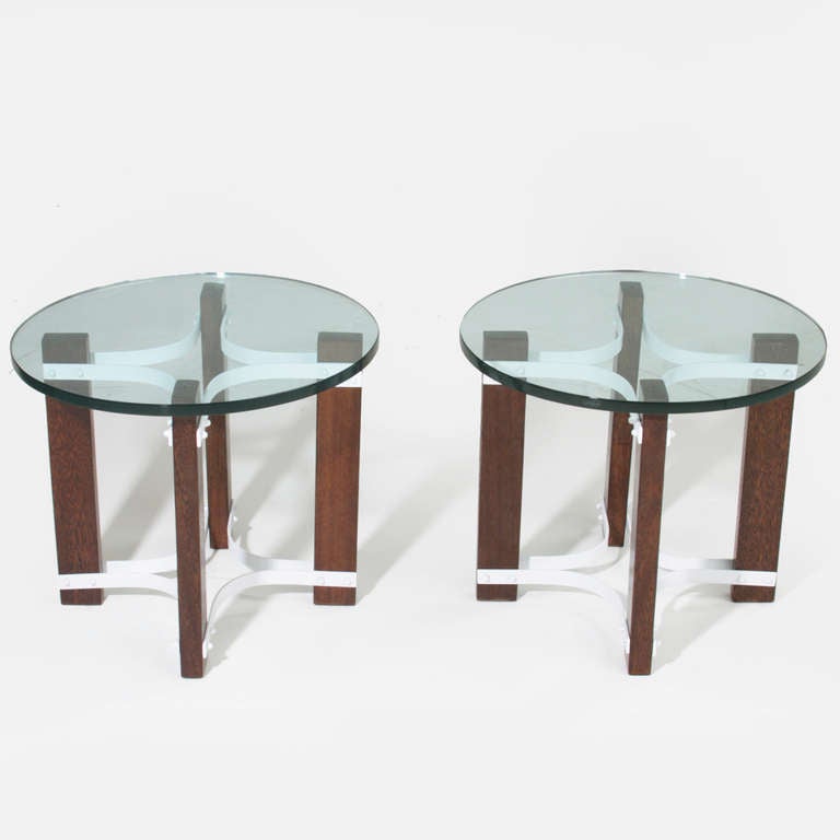 Pair of round glass side tables from Brazil with white finished steel star shaped bases. On each corner of the base there is solid Sucupira wood that attaches the top of the base to the bottom. 

A matching round coffee table is also available in