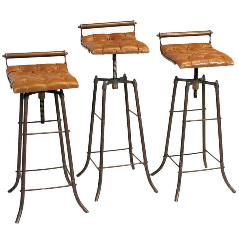 Set of 3 bronze and tufted leather bar stools from Brazil