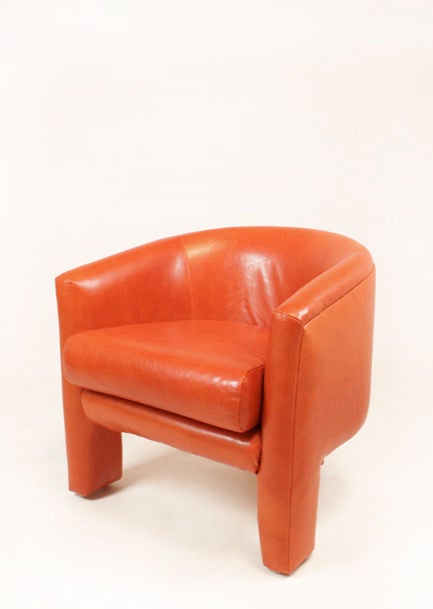 Pair of Milo Baughman orange leather three legged arm chairs