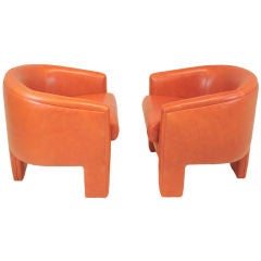 Pair of Milo Baughman orange leather three legged arm chairs
