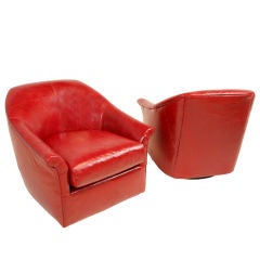 Pair of red leather winged swivel chairs