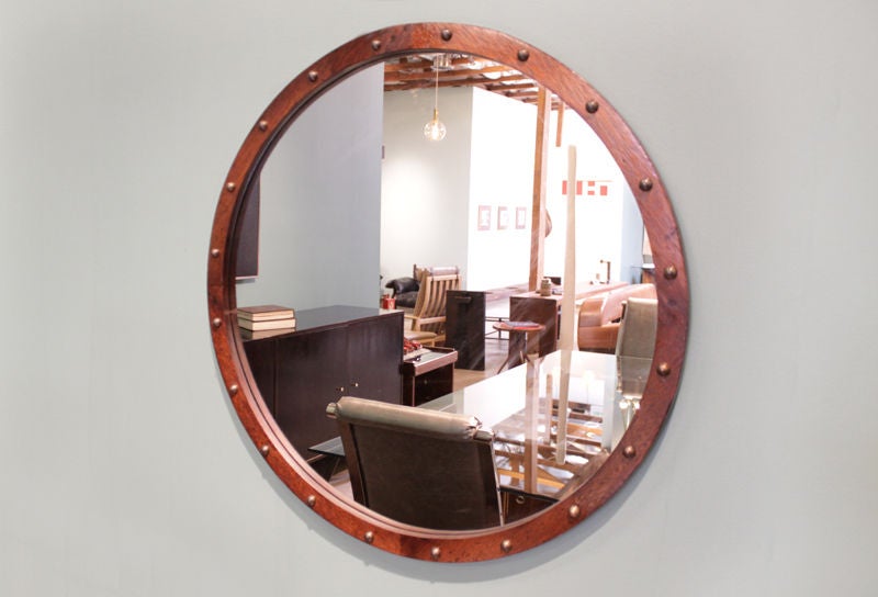 A lovely round mirror in Brazilian exotic hardwood with a clean edge and adorned with patinated bronze half circles. 

These mirrors were purchased from a hotel in San Paolo Brazil. the interior was done in the 1960s. We are unable to identify the