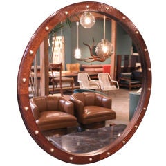 Round Brazilian Baruna wood mirror with polished brass details