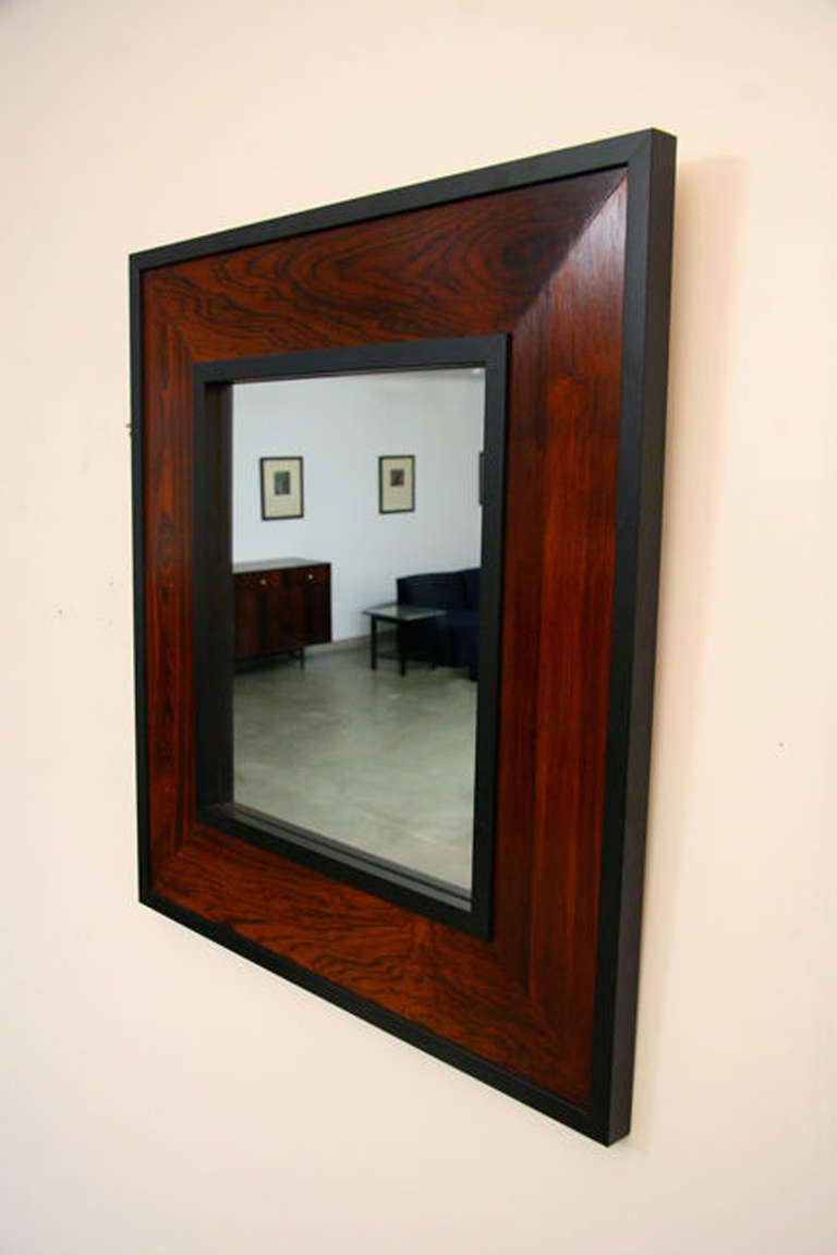 A mirror framed in Brazilian Rosewood and painted wood trim designed by. Frame is made from scraps of salvaged rosewood paneling.

Many pieces are stored in our warehouse, so please click on CONTACT DEALER under our logo below to find out if the