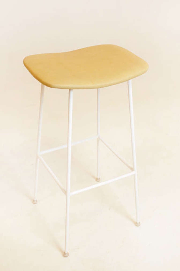 A smaller version of the Bunda Stool with slimmer solid steel frame and curved upholstered seat by Thomas Hayes Studio. 

This item is available for custom order and the lead time is 6-8 weeks; sometimes we are able to complete projects faster, so